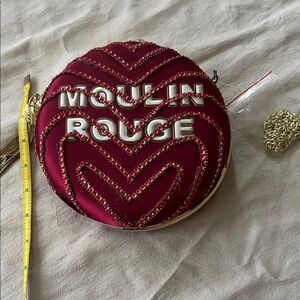 Red hand decorated satin bag with gold tassel and strap included